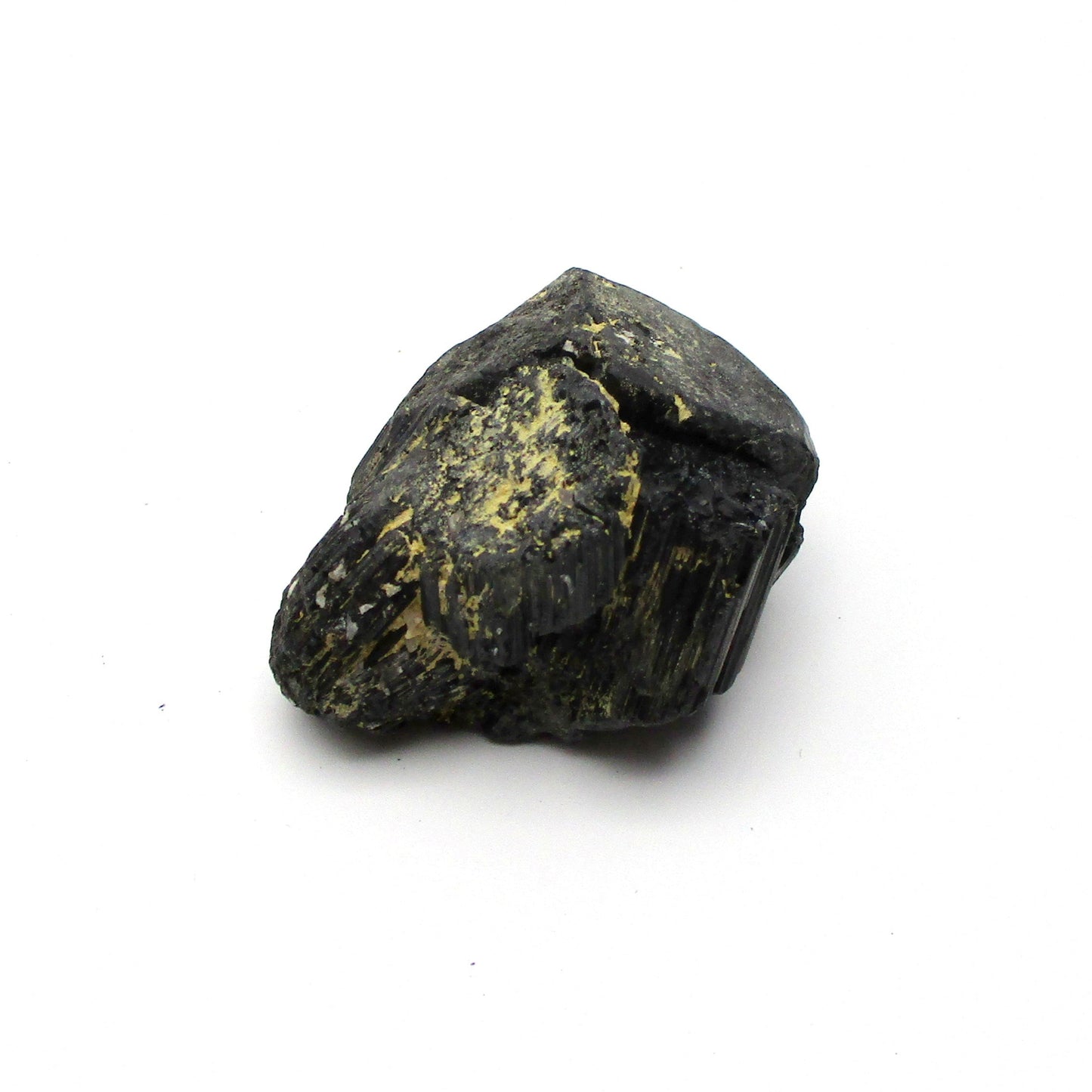 A rough, black tourmaline crystal with a metallic sheen, approximately 1 inch in size, displayed on a white background.