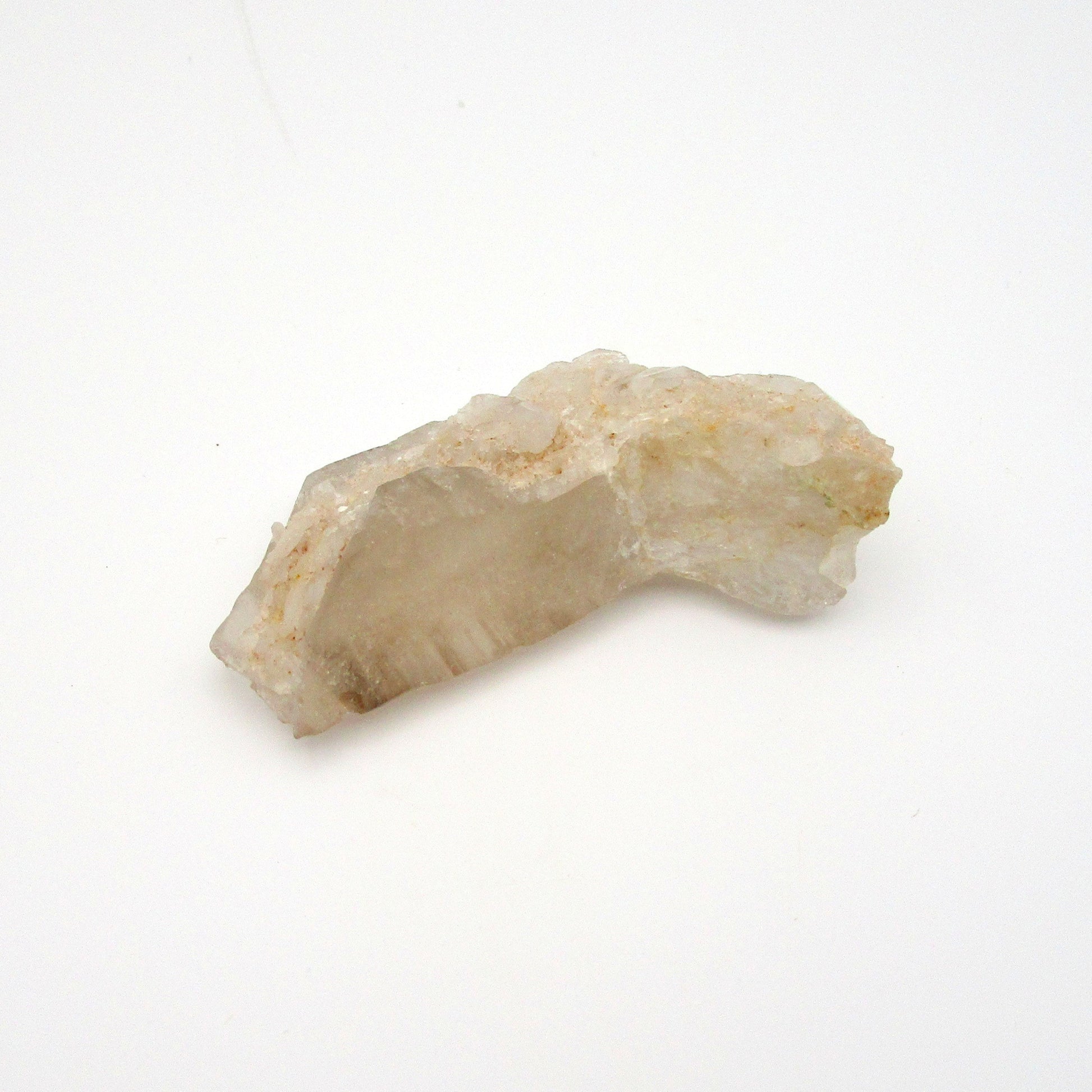 A rough, uncut Russian Quartz crystal point against a white background.
